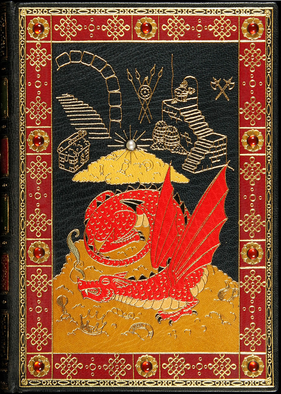 On the front cover, in a cave-fortress drawn in gilt, a sinuous red dragon guards piles of treasure surmounted by a radiant pearl (presumably representing the Arkenstone of Thrain).