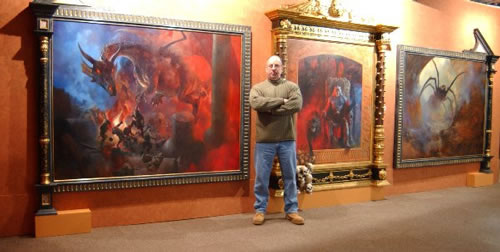 Paul Raymond Gregory in front of his massive paintings
